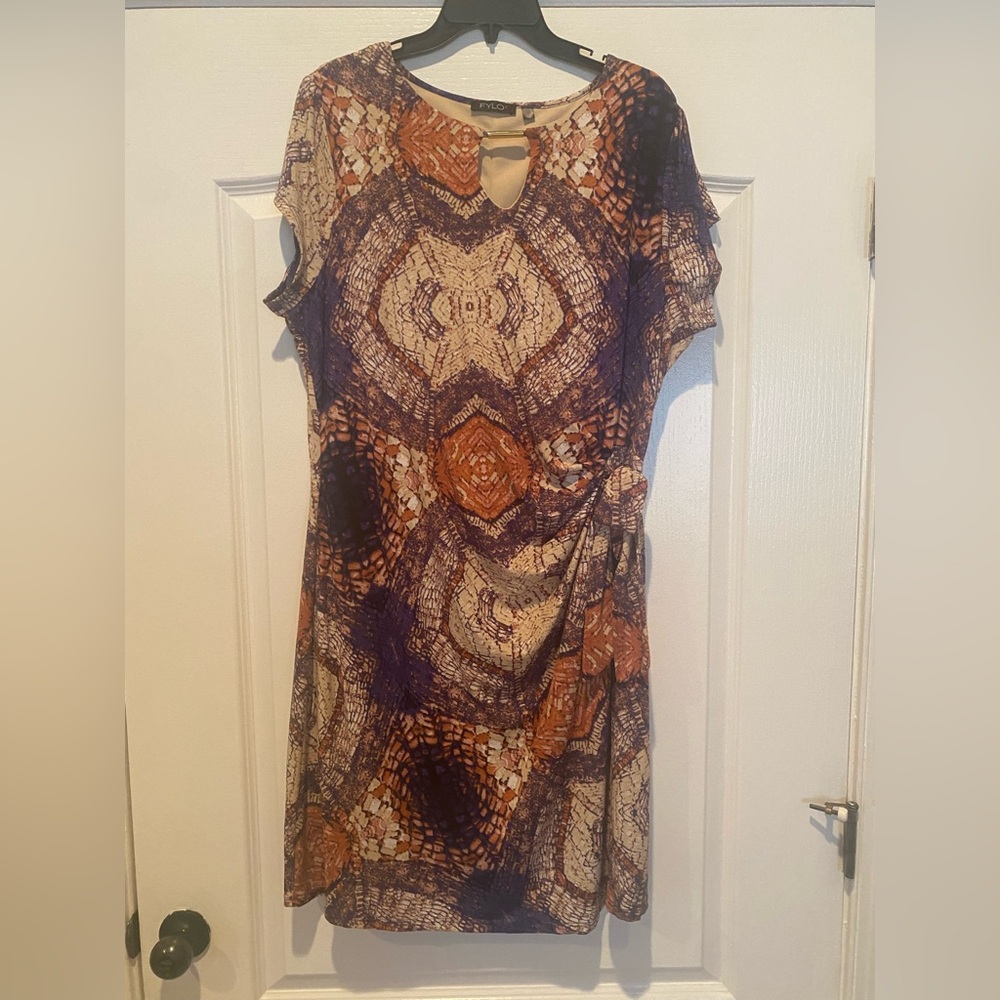 Faux wrap dress with gold neckline hardware.
